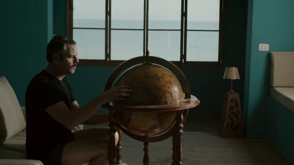 Character Mounir is checking a globe